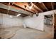 Unfinished basement with exposed wood ceiling and concrete block walls at 521 Kessler Blvd E Dr, Indianapolis, IN 46220