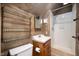 Bathroom with brown walls, a sink, a toilet, and a shower at 521 Kessler Blvd E Dr, Indianapolis, IN 46220