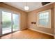 Bedroom with hardwood floors, a sliding door, and a window with a view of the backyard at 521 Kessler Blvd E Dr, Indianapolis, IN 46220