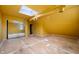 Bedroom with yellow walls, bare floors, mirrored closet doors, and a skylight at 521 Kessler Blvd E Dr, Indianapolis, IN 46220