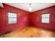 Simple bedroom with hardwood floors and natural light from two windows at 521 Kessler Blvd E Dr, Indianapolis, IN 46220