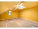 Bedroom with yellow walls, bare floors, and a skylight at 521 Kessler Blvd E Dr, Indianapolis, IN 46220