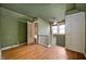 Upstairs room with green walls, hardwood floors, and a bathroom adjacent at 521 Kessler Blvd E Dr, Indianapolis, IN 46220