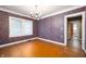 Bright dining room features decorative wallpaper, hardwood floors, and classic chandelier at 521 Kessler Blvd E Dr, Indianapolis, IN 46220