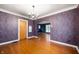 Dining room with hardwood floors, an ornate chandelier, and detailed wallpaper at 521 Kessler Blvd E Dr, Indianapolis, IN 46220
