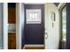 Inviting entryway with a unique, arched door, stained glass, and hardwood floors at 521 Kessler Blvd E Dr, Indianapolis, IN 46220