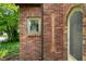Detailed view of the brick exterior with a decorative arrow and lush greenery at 521 Kessler Blvd E Dr, Indianapolis, IN 46220