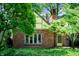 Beautiful brick house featuring a gable roof and a well-maintained yard with mature trees at 521 Kessler Blvd E Dr, Indianapolis, IN 46220
