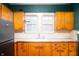 Kitchen with vintage wooden cabinets, white countertops, and a double window at 521 Kessler Blvd E Dr, Indianapolis, IN 46220