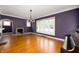 Spacious living room with hardwood floors, decorative windows, and a classic fireplace at 521 Kessler Blvd E Dr, Indianapolis, IN 46220