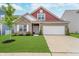 Charming two-story home featuring a brick facade, two-car garage and well-manicured lawn at 5304 Maywood Dr, Whitestown, IN 46075