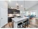 Open kitchen features a central island with breakfast bar, modern appliances, and pendant lighting at 5304 Maywood Dr, Whitestown, IN 46075
