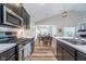 Bright kitchen boasts stainless steel appliances, white countertops, and seamless flow into the dining area at 5304 Maywood Dr, Whitestown, IN 46075