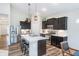 Stylish kitchen featuring a center island with seating, stainless appliances, and modern lighting at 5304 Maywood Dr, Whitestown, IN 46075