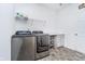 Laundry room with modern washer and dryer, counter space, and storage shelves for supplies at 5304 Maywood Dr, Whitestown, IN 46075
