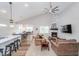 Open-concept living room with fireplace, large ceiling fan, and ample seating at 5304 Maywood Dr, Whitestown, IN 46075