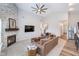 Bright living room with an open layout, connecting the kitchen, dining area, and fireplace at 5304 Maywood Dr, Whitestown, IN 46075