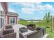 Back patio boasts comfortable seating, an outdoor fire pit, and a picturesque view at 5304 Maywood Dr, Whitestown, IN 46075