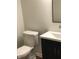 Modern bathroom featuring toilet and vanity with stylish mirror above sink at 6070 Southbay Dr, Indianapolis, IN 46250