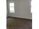 This bedroom features neutral walls, plush carpeting, and natural light from the windows at 6070 Southbay Dr, Indianapolis, IN 46250
