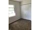 Bedroom featuring a window and a spacious closet for ample storage at 6070 Southbay Dr, Indianapolis, IN 46250