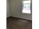 A bright bedroom with plush carpet and a window that invites natural light at 6070 Southbay Dr, Indianapolis, IN 46250