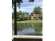 Picturesque view of lakeside townhomes nestled among lush greenery, reflecting in calm water at 6070 Southbay Dr, Indianapolis, IN 46250