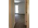 A hallway leads to a sunlit room with a glass-paneled door at 6070 Southbay Dr, Indianapolis, IN 46250