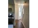 Hallway with wood floors leads past an updated kitchen and stairs to the upper level at 6070 Southbay Dr, Indianapolis, IN 46250