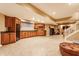 Finished basement features a kitchenette area with wood cabinets, tile flooring and adjacent entertainment and fitness area at 626 N Senate Ave, Indianapolis, IN 46202
