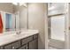Bathroom with a vanity with chrome fixtures and a shower with sliding glass doors at 626 N Senate Ave, Indianapolis, IN 46202