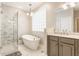 A sleek white tub sits next to a glass-enclosed shower and vanity in this contemporary bathroom at 626 N Senate Ave, Indianapolis, IN 46202