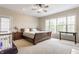 Spacious bedroom with a large window, neutral carpet, and a ceiling fan at 626 N Senate Ave, Indianapolis, IN 46202