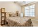 Cozy bedroom with warm lighting, a patterned bedspread, and a bright window at 626 N Senate Ave, Indianapolis, IN 46202