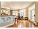 Bright dining area with hardwood floors, French doors, and an open layout to the kitchen at 626 N Senate Ave, Indianapolis, IN 46202