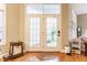 Inviting foyer with double french doors, hardwood floors, and ample natural light at 626 N Senate Ave, Indianapolis, IN 46202