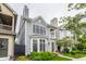 Charming two-story home with gray siding, bay window, front porch, and professionally landscaped yard at 626 N Senate Ave, Indianapolis, IN 46202