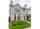 Charming two-story home with gray siding, bay window, front porch, and professionally landscaped yard at 626 N Senate Ave, Indianapolis, IN 46202