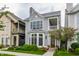 Charming two-story home with gray siding, bay window, front porch, and professionally landscaped yard at 626 N Senate Ave, Indianapolis, IN 46202
