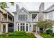 Charming two-story home with gray siding, bay window, front porch, and professionally landscaped yard at 626 N Senate Ave, Indianapolis, IN 46202