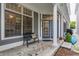 Inviting front porch with a cozy bench, stylish rug, and a blue front door at 626 N Senate Ave, Indianapolis, IN 46202