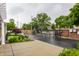 Gated entrance to a property featuring brick pillars, a black metal gate, and landscaping at 626 N Senate Ave, Indianapolis, IN 46202