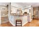 Well-equipped kitchen with white cabinets, granite countertops, and a breakfast bar at 626 N Senate Ave, Indianapolis, IN 46202