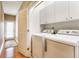 Laundry room featuring new washer and dryer with white cabinets, offering practicality and storage at 626 N Senate Ave, Indianapolis, IN 46202