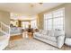 Comfortable living room with large windows, hardwood floors, and an open layout to the dining area at 626 N Senate Ave, Indianapolis, IN 46202