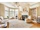Bright living room with large windows, a ceiling fan, fireplace, and comfortable seating at 626 N Senate Ave, Indianapolis, IN 46202