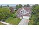 Aerial view of a charming two-story home, showcasing its well-maintained lawn and mature trees at 6549 Wilshire Pl, Zionsville, IN 46077