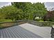A spacious back deck offers a serene outdoor space with views of the lush, tree-filled backyard at 6549 Wilshire Pl, Zionsville, IN 46077