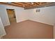 Basement with painted concrete floors, a small window, and exposed ceiling with hanging ductwork at 6549 Wilshire Pl, Zionsville, IN 46077