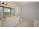 Bathroom with a double sink vanity, soaking tub, and modern fixtures at 6549 Wilshire Pl, Zionsville, IN 46077